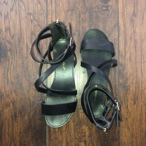Black gladiator sandals with buckle details